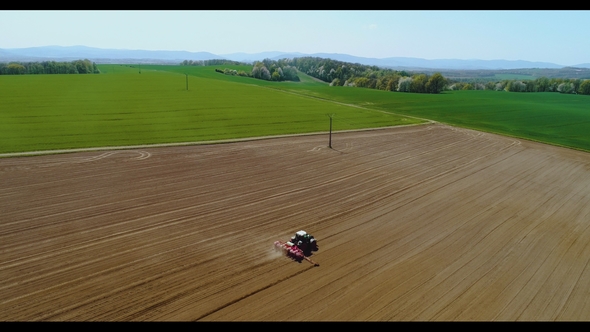 Tractor Working in Beautiful Spacious Agricultural Field alt