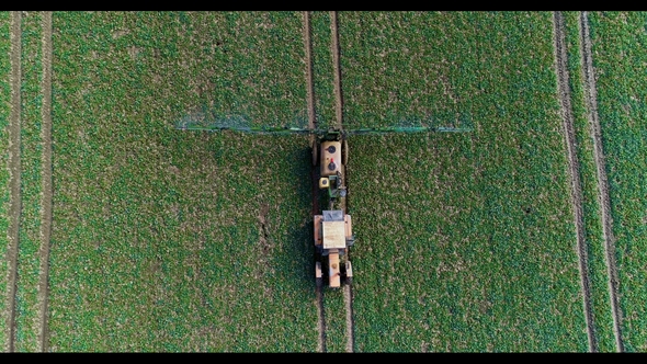 Tractor Spray Fertilize on Field with Chemicals in Agriculture Field alt