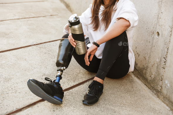Cropped photo of handicapped woman having bionic leg in streetwe Stock Photo by vadymvdrobot
