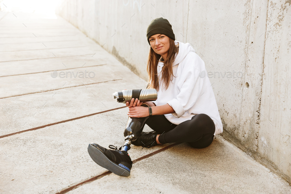 Photo of smiling young handicapped woman having bionic leg in st Stock Photo by vadymvdrobot