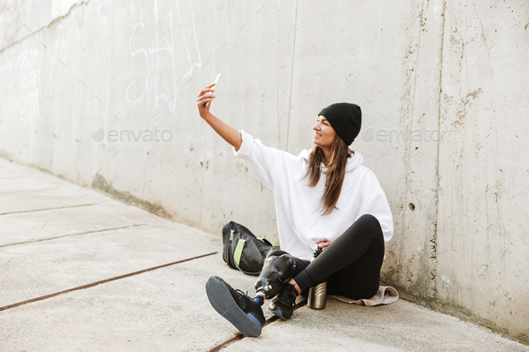 Photo of modern young handicapped woman in streetwear having bio - Stock Photo - Images