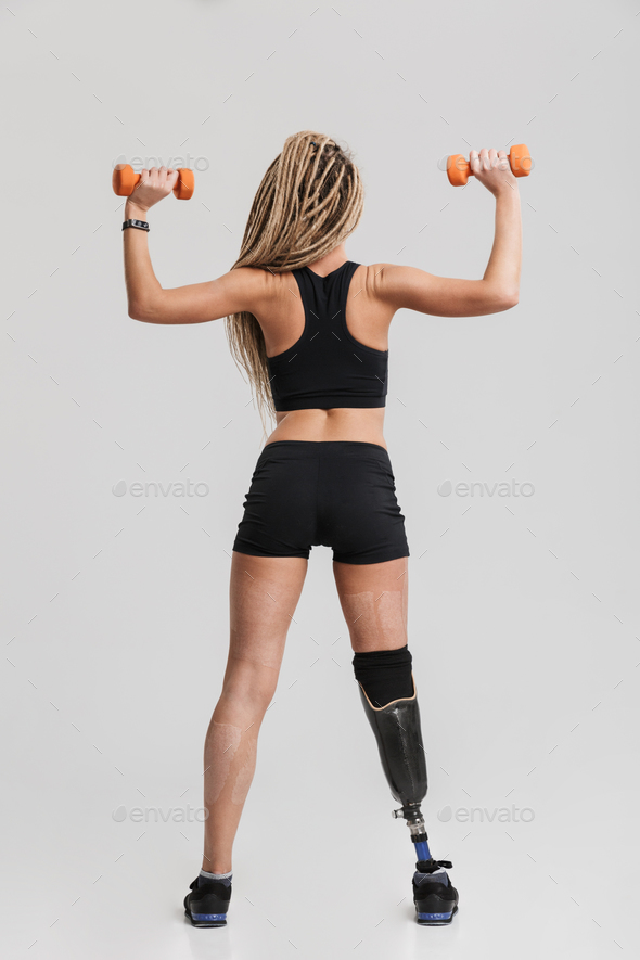 Healthy young disabled sportswoman make exercises with dumbbells. - Stock Photo - Images