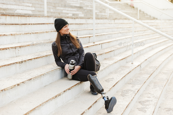 Photo of happy handicapped woman in black sportswear with prosth - Stock Photo - Images