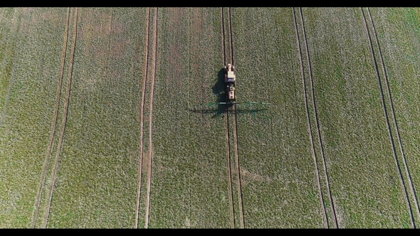 Tractor Spray Fertilize on Field with Chemicals in Agriculture Field alt
