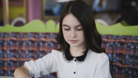 Pretty Girl Reading the Menu and Making an Order alt