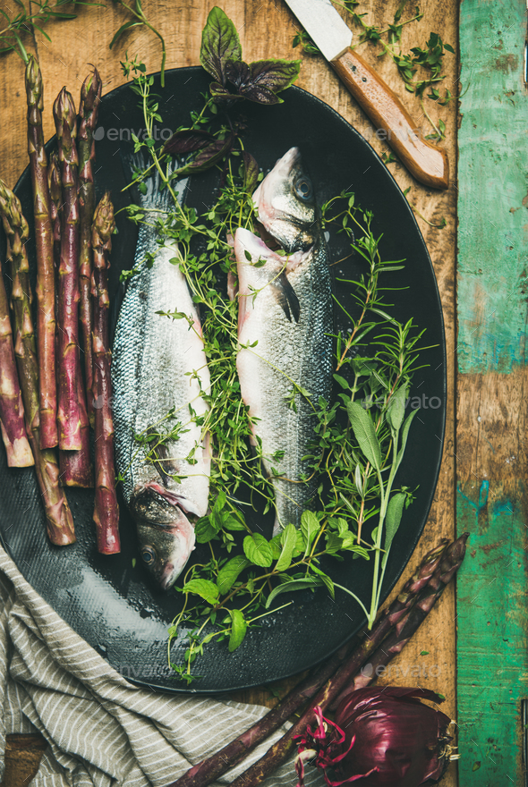 Raw incooked sea bass with herbs - Stock Photo - Images