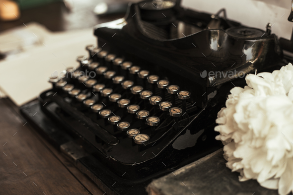 Old black typewriter with paper worth on the table - Stock Photo - Images