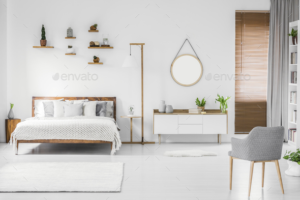 Spacious designer white bedroom interior with wooden bed with be - Stock Photo - Images