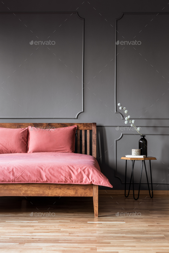 Real photo of a simple and elegant bed with dirty pink bedding n Stock Photo by bialasiewicz