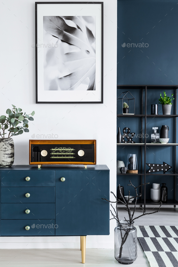 Close-up of a painting, blue cabinet, retro radio and glass vase - Stock Photo - Images