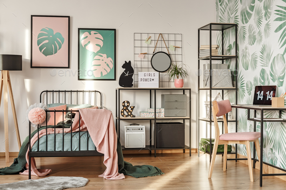 Framed posters above twin bed - Stock Photo - Images