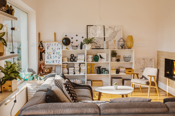 Sun coming through a large window into a cozy, scandinavian livi - Stock Photo - Images