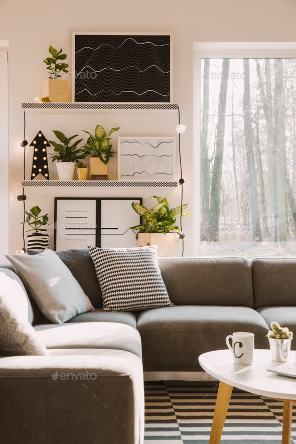 Pillows with pattern on grey corner couch standing in bright Nor - Stock Photo - Images