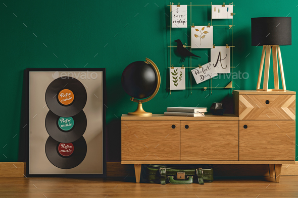 Green bag under retro dresser - Stock Photo - Images