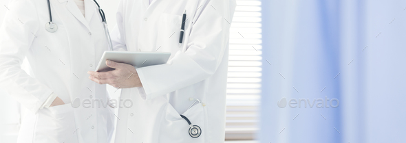 Doctor consulting with a colleague - Stock Photo - Images