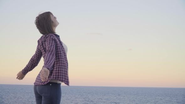 Young Woman Standing on Top of a Mountain and Looking at the Sea, Sunset, Greece, Crete