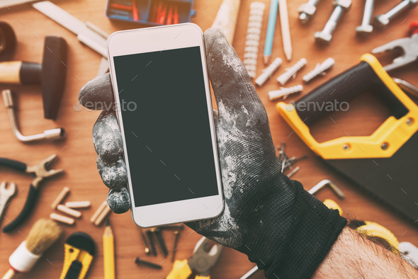 Smart phone app for handyman, repairman holding mobile phone - Stock Photo - Images