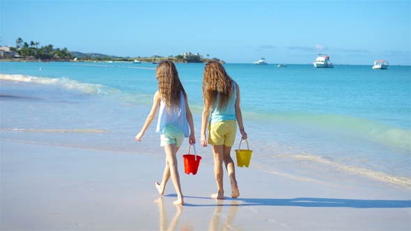 Adorable Little Girls Walking on the Beach and Having Fun Together