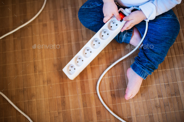 Toddler boy in dangerous situation at home. Child safety concept. - Stock Photo - Images