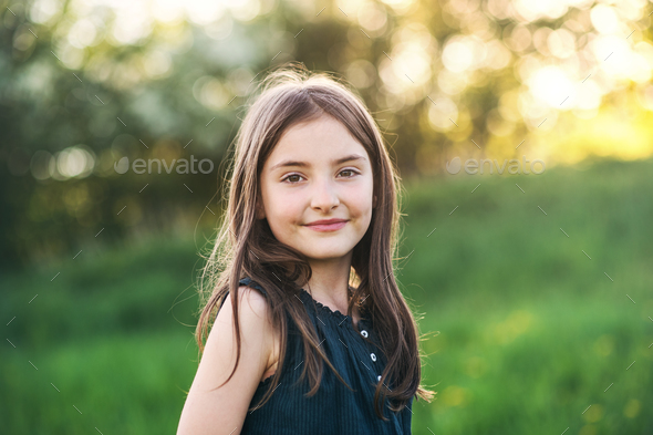 A small girl standing outside in nature. Stock Photo by halfpoint | PhotoDune