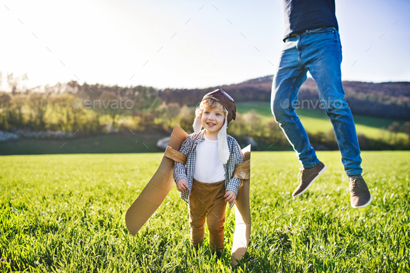 Happy toddler boy playing outside with father in spring nature. - Stock Photo - Images