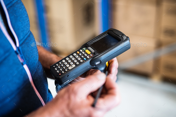 Male warehouse worker with barcode scanner. - Stock Photo - Images