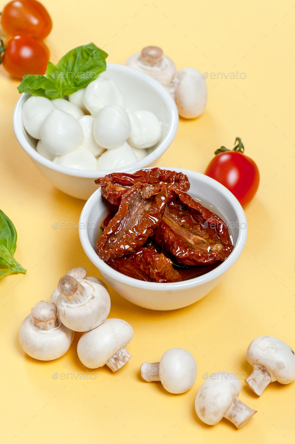 Sun-dried tomatoes, champignon mushrooms, Mozzarella cheese and - Stock Photo - Images