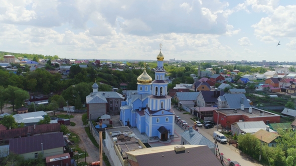 Orthodox Church with Golden Domes Under Cloudy Sky alt
