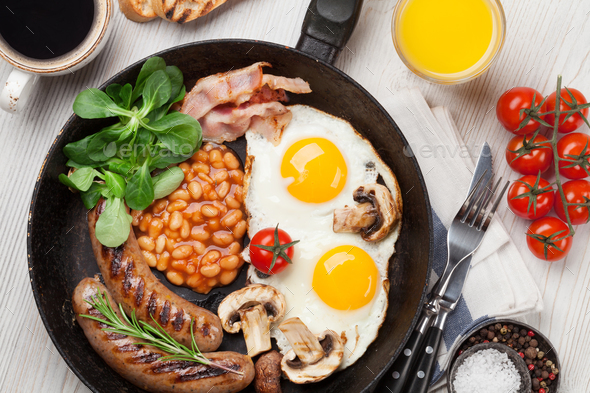 English breakfast. Fried eggs, sausages, bacon - Stock Photo - Images