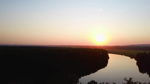 Aerial Video of the Lake on a Warm Summer Day in Light of the Setting Sun alt