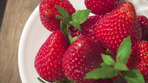 Strawberry on a Plate and a Glass with Natural Juice