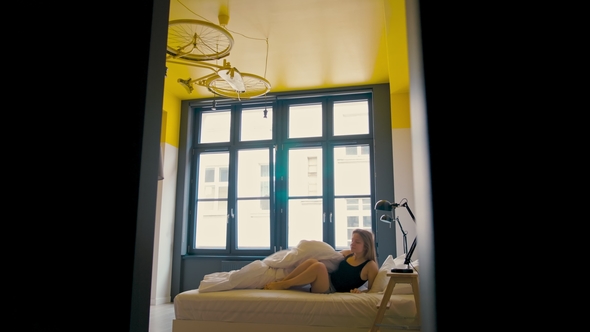 Lady Is Waking Up in a Bedroom, Stretching and Getting Out of Bed in the Morning alt