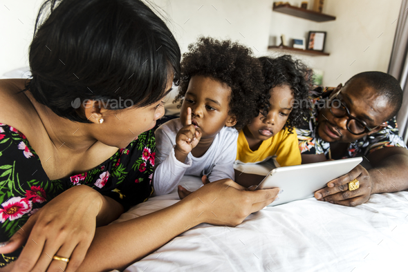 African family on bed using a tablet Stock Photo by Rawpixel | PhotoDune