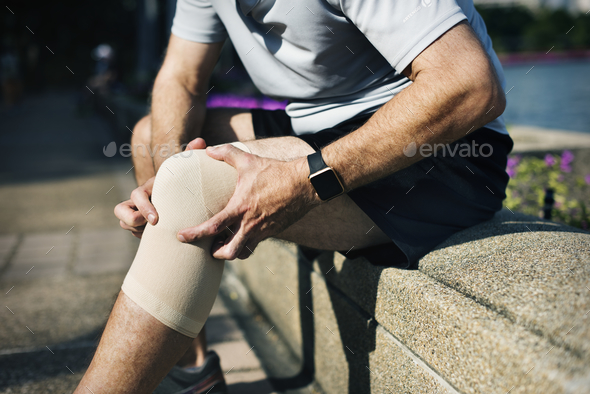 Elderly man having a knee injury - Stock Photo - Images