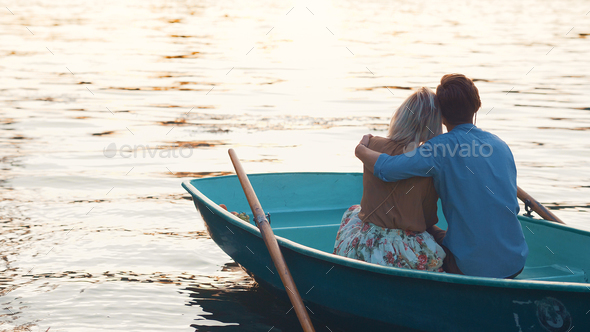 Embracing couple in a boat Stock Photo by AboutImages | PhotoDune