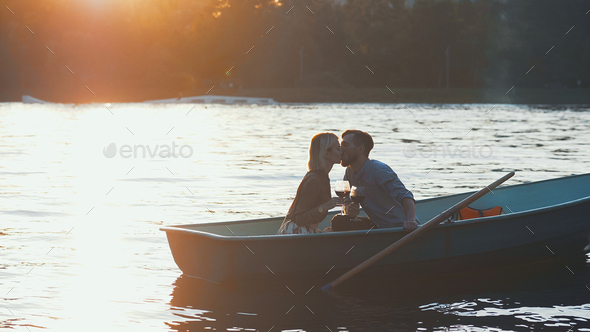 Kissing young couple in a boat Stock Photo by AboutImages | PhotoDune