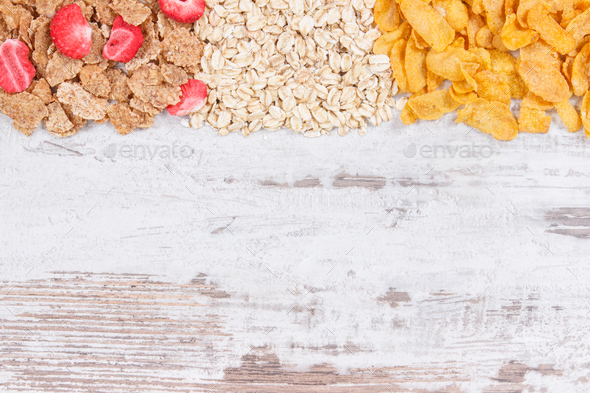 Various mix flakes as source carbohydrates, minerals and fiber, copy space for text on board - Stock Photo - Images