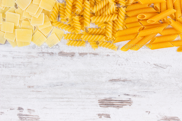 Various mix pasta as source carbohydrates and fiber, copy space for text on board - Stock Photo - Images