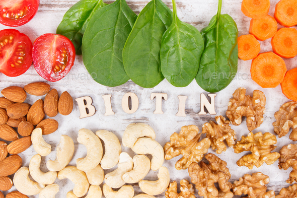 Inscription biotin with nutritious products containing vitamin B7 and dietary fiber - Stock Photo - Images