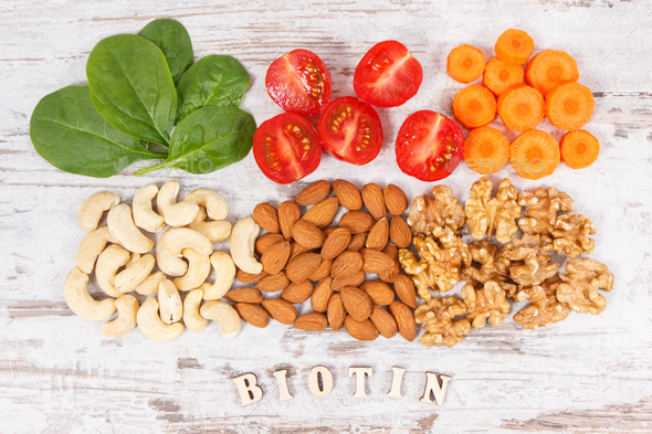 Inscription biotin with nutritious products containing vitamin B7 and dietary fiber - Stock Photo - Images