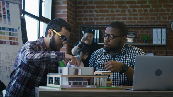 Men Collaborating on New House Project alt