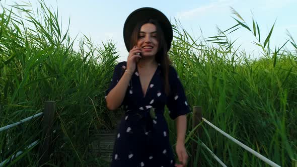 Happy Woman Talking On The Phone Smiling alt