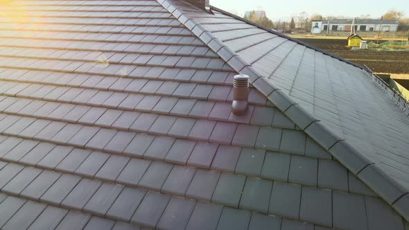 Closeup of Ventilation Pipe on House Roof Top Covered with Ceramic Shingles alt