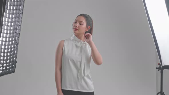 Behind The Scenes On Photo Shoot: Beautiful Asian Model Poses For A Photographer alt