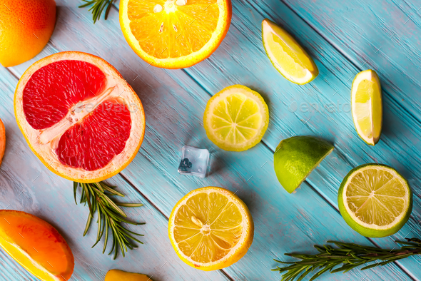 Pattern of slice citrus on blue wooden background - Stock Photo - Images