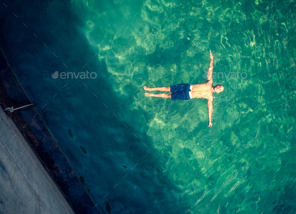 Man relaxing in the pool - Stock Photo - Images