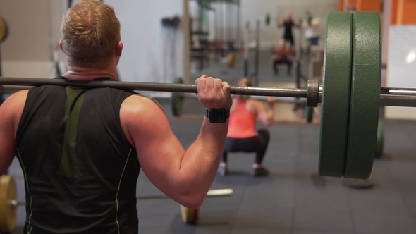 Fitness People Doing Back Squat Exercise in Gym