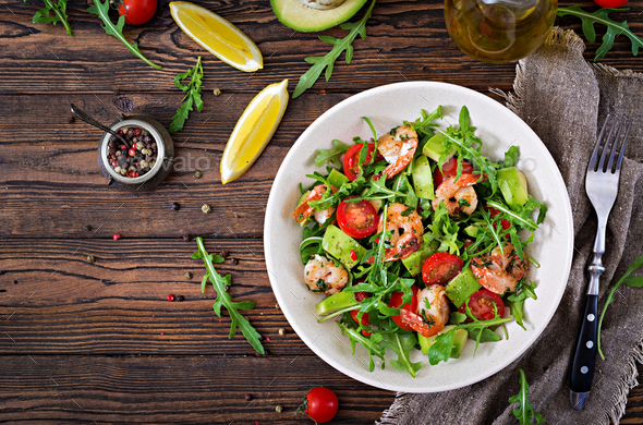 Fresh salad bowl with shrimp, tomato, avocado and arugula - Stock Photo - Images