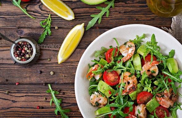 Fresh salad bowl with shrimp, tomato, avocado and arugula - Stock Photo - Images