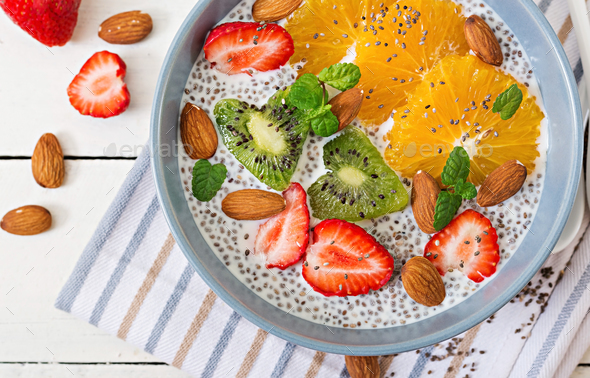 Vegan almond milk chia seeds pudding with strawberries, orange and kiwi. - Stock Photo - Images
